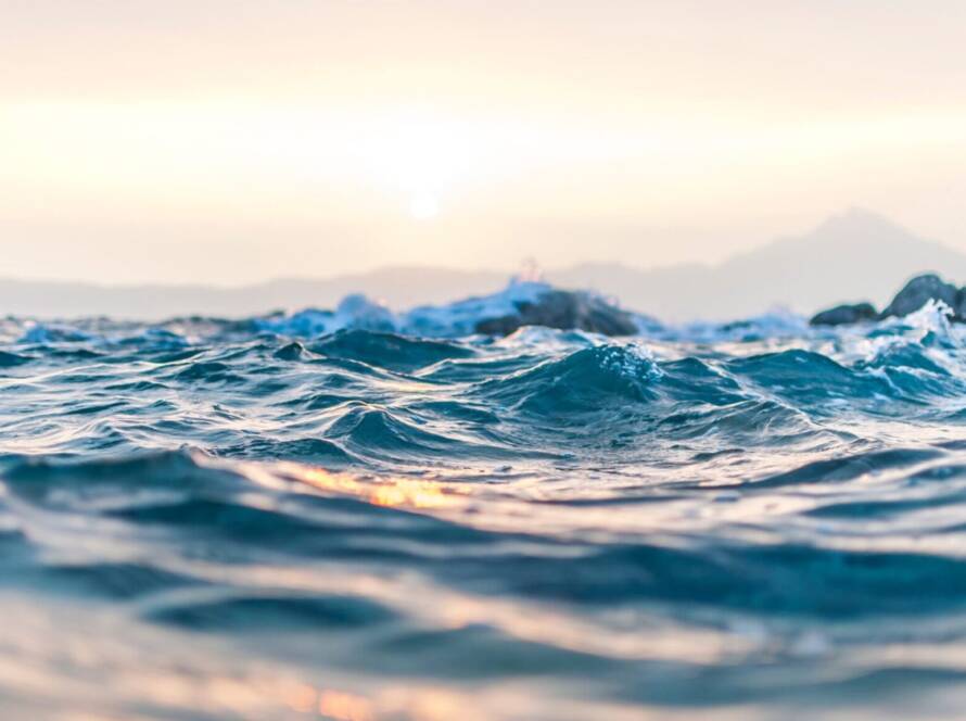 Close-up of ocean waves at sunset.