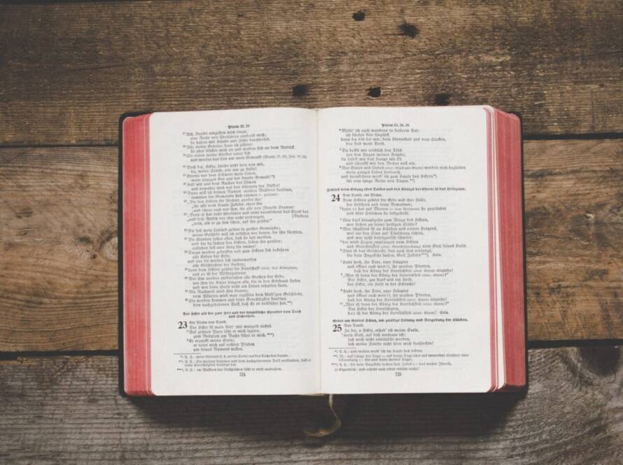 Open German Bible on wood table.