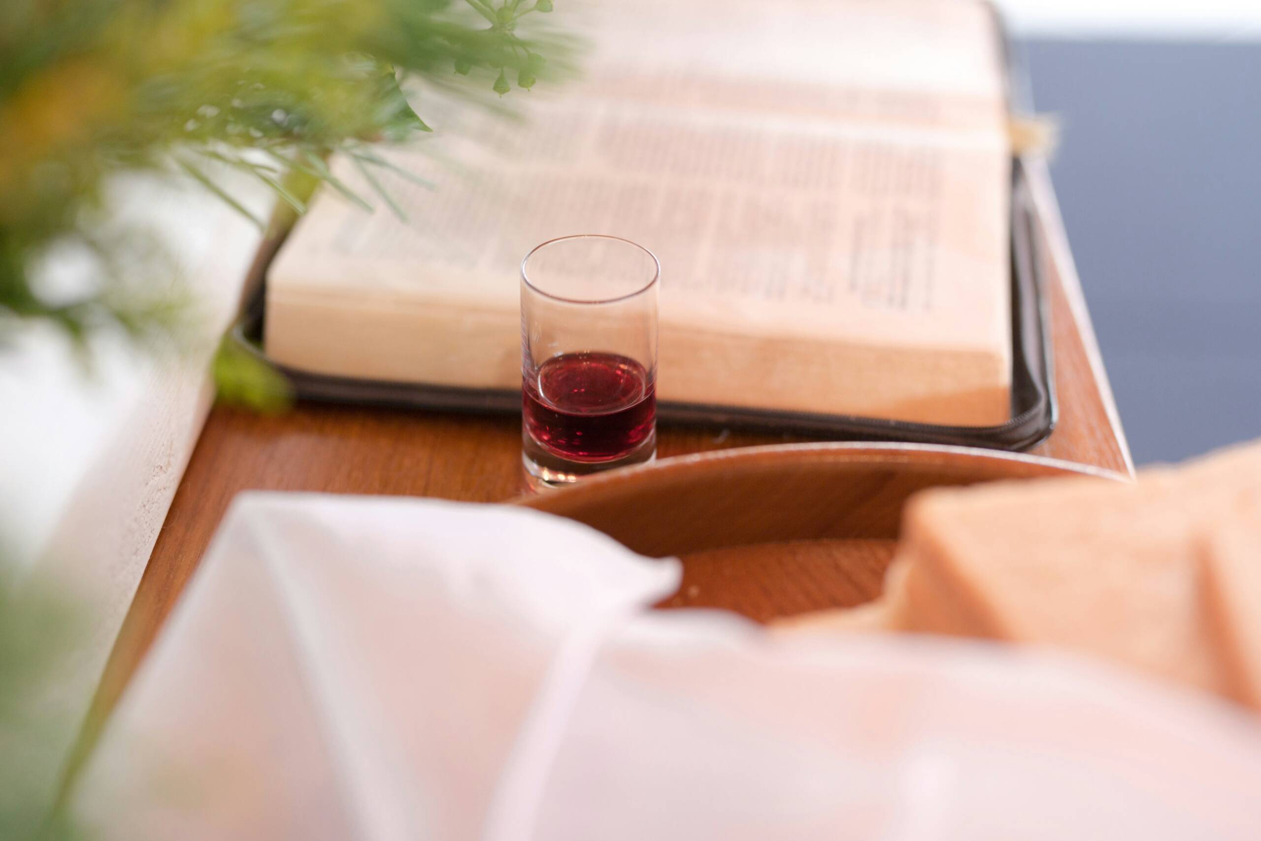 A glass of wine and some books on the table