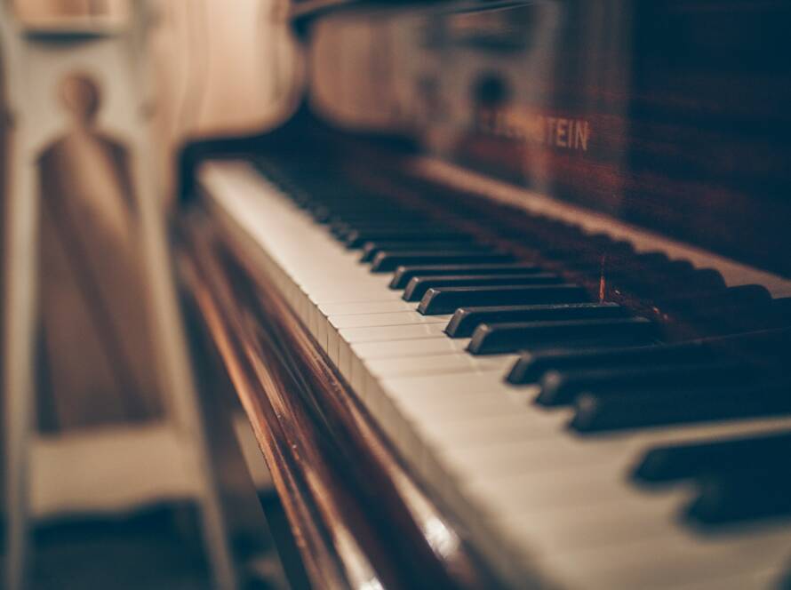 A close up of the keys on an old piano