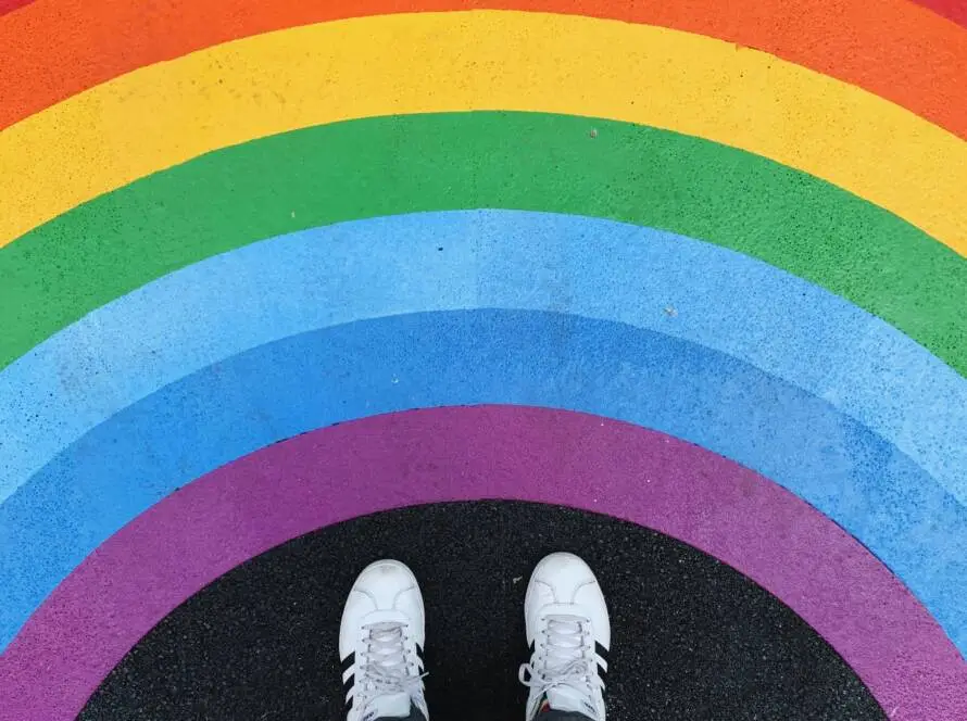 A person standing on top of a rainbow.