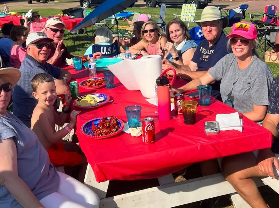 A group of people sitting at a picnic table.