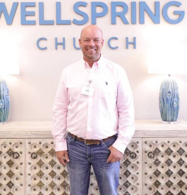 Man standing in front of Wellspring Church.
