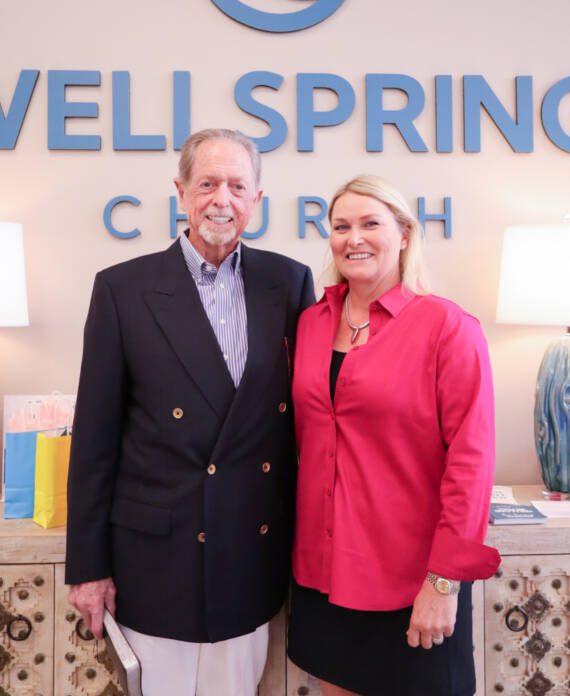 Man and woman standing in church lobby.