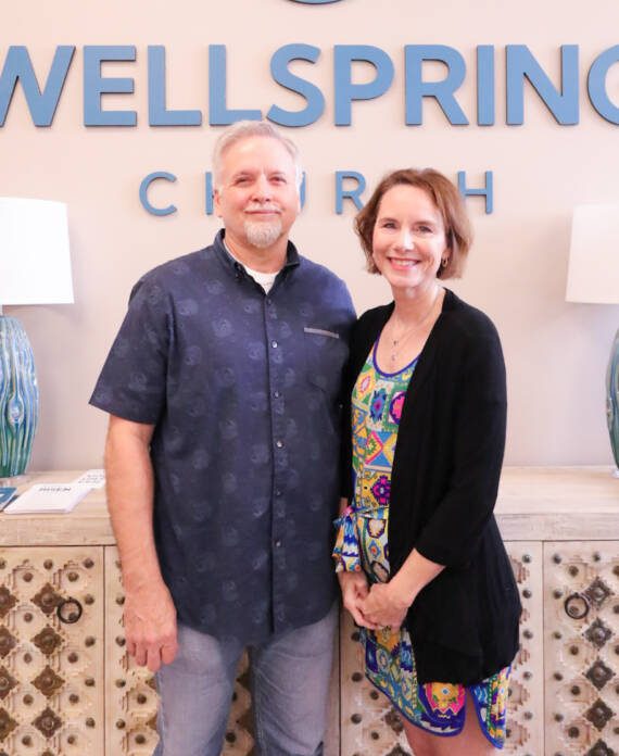 Man and woman smiling at Wellspring Church.