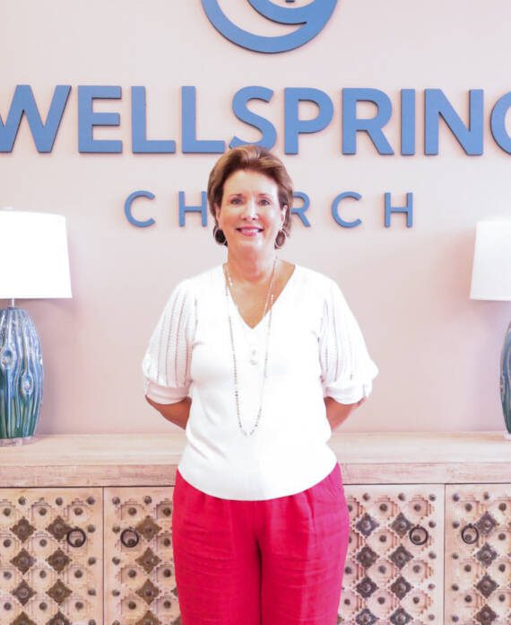 Person standing in front of Wellspring Church.
