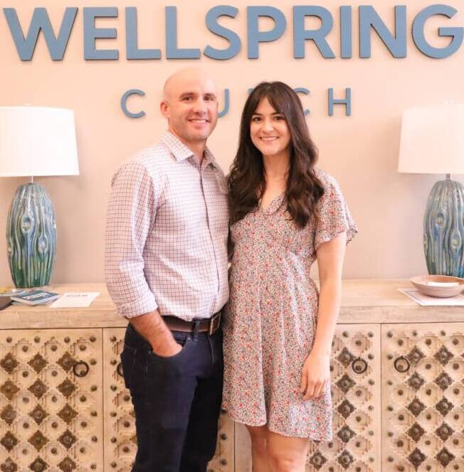 Couple smiling at Wellspring Church entrance.