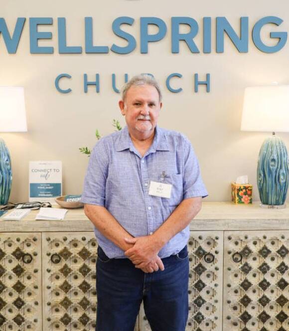 Man standing in front of Wellspring Church.