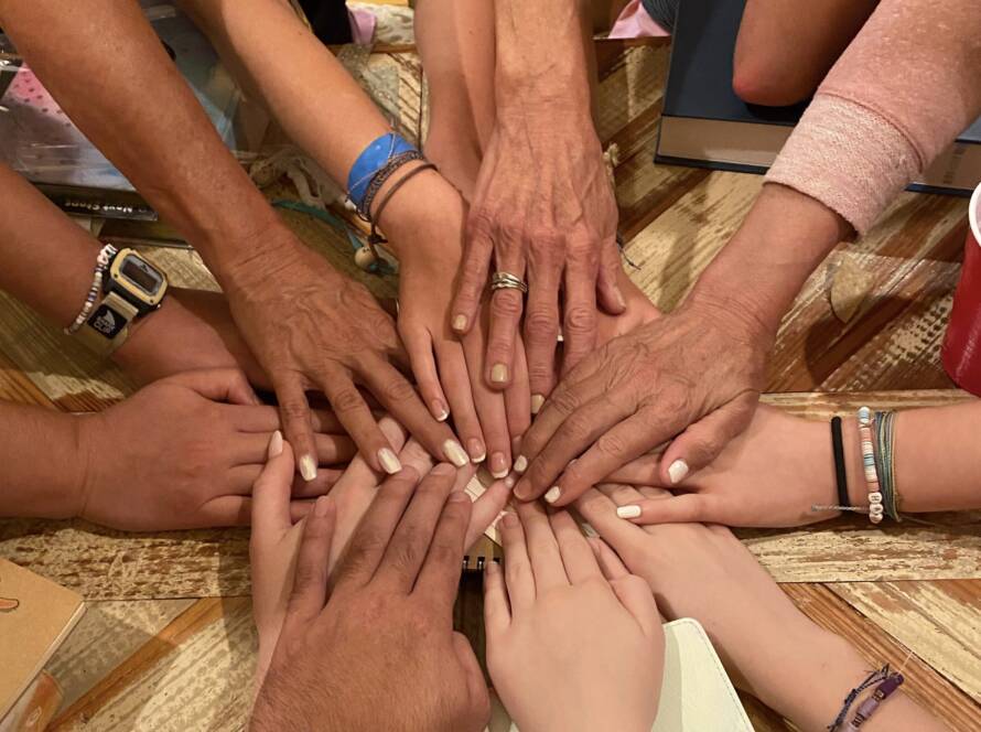 Hands of diverse people touching together.