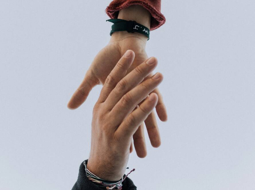 Two hands reaching towards each other.