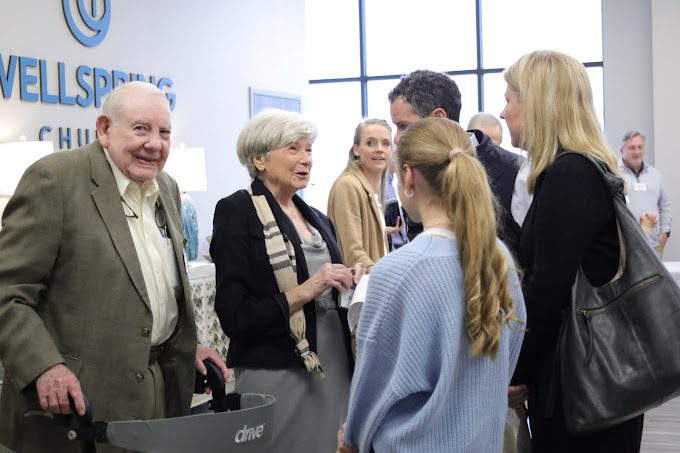 Group of people talking at an event.