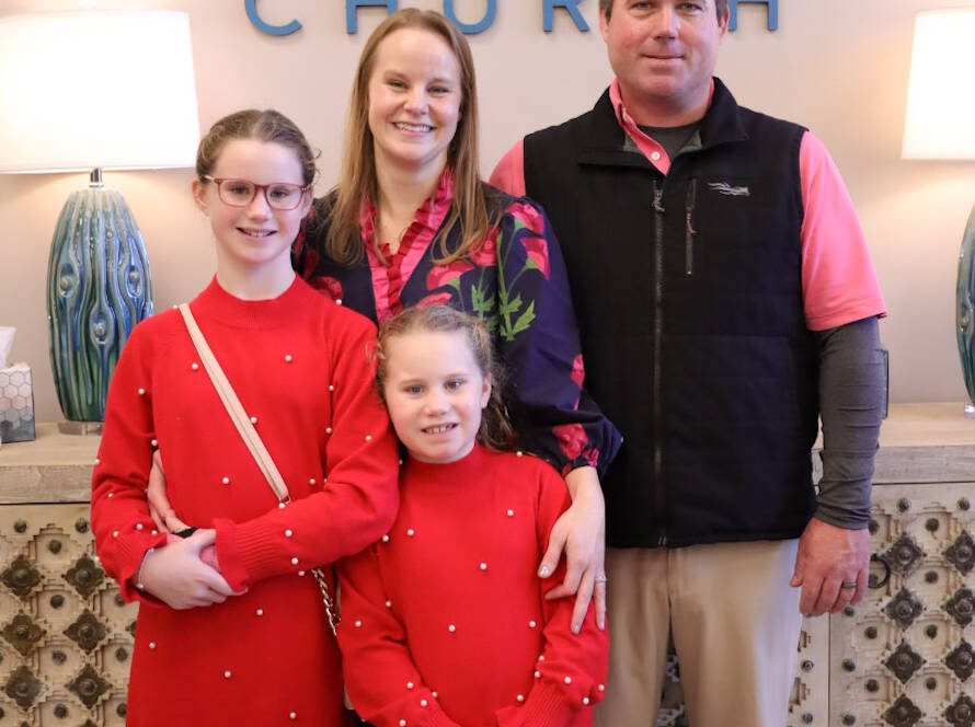 Family posing at Wellspring Church entrance.