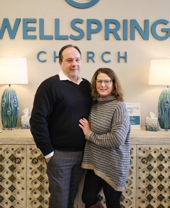 Couple standing in front of Wellspring Church.