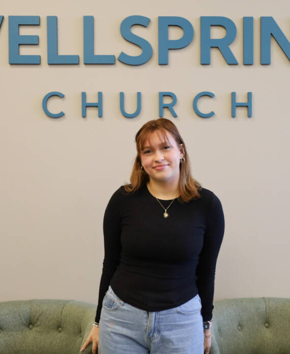 Person standing in front of Wellspring Church.