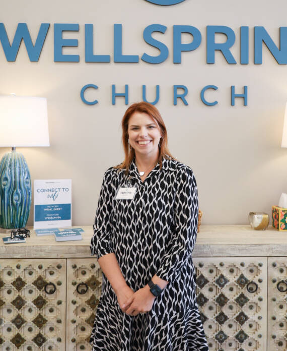Woman standing in front of Wellspring Church.