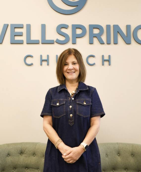 Woman standing in front of Wellspring Church.
