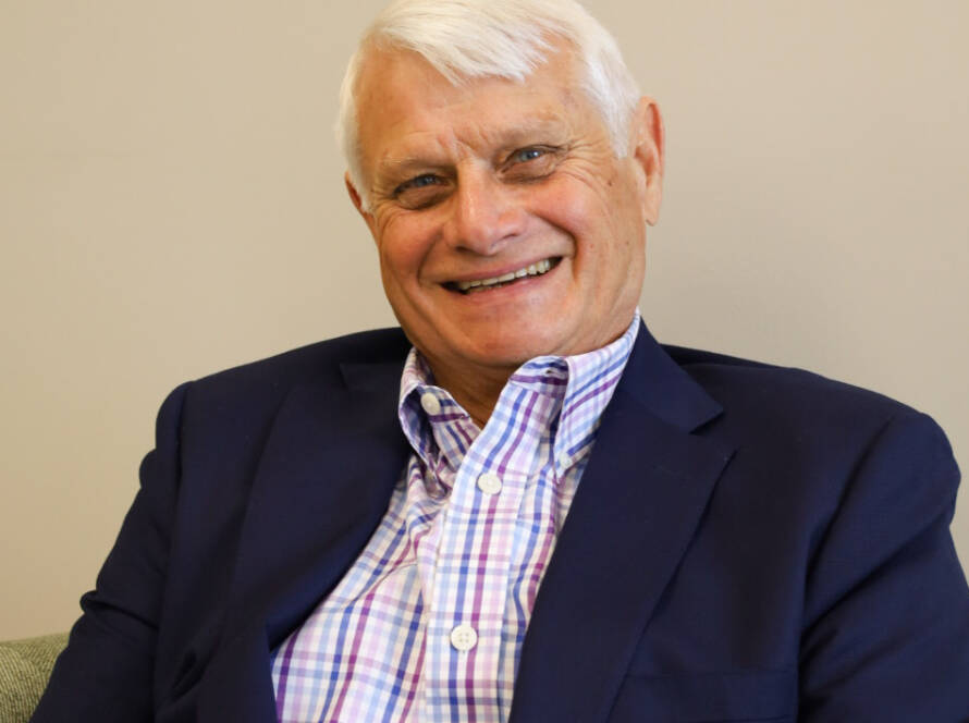 Smiling older man in blazer and checked shirt