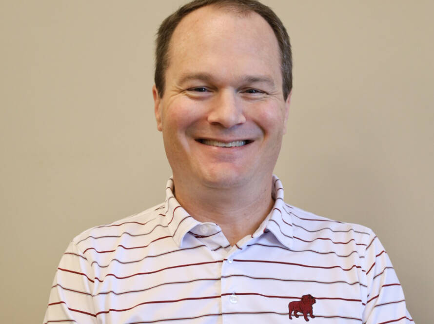 Smiling man in striped polo shirt