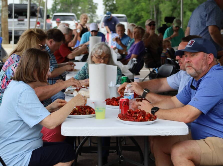 People enjoying outdoor crawfish boil together