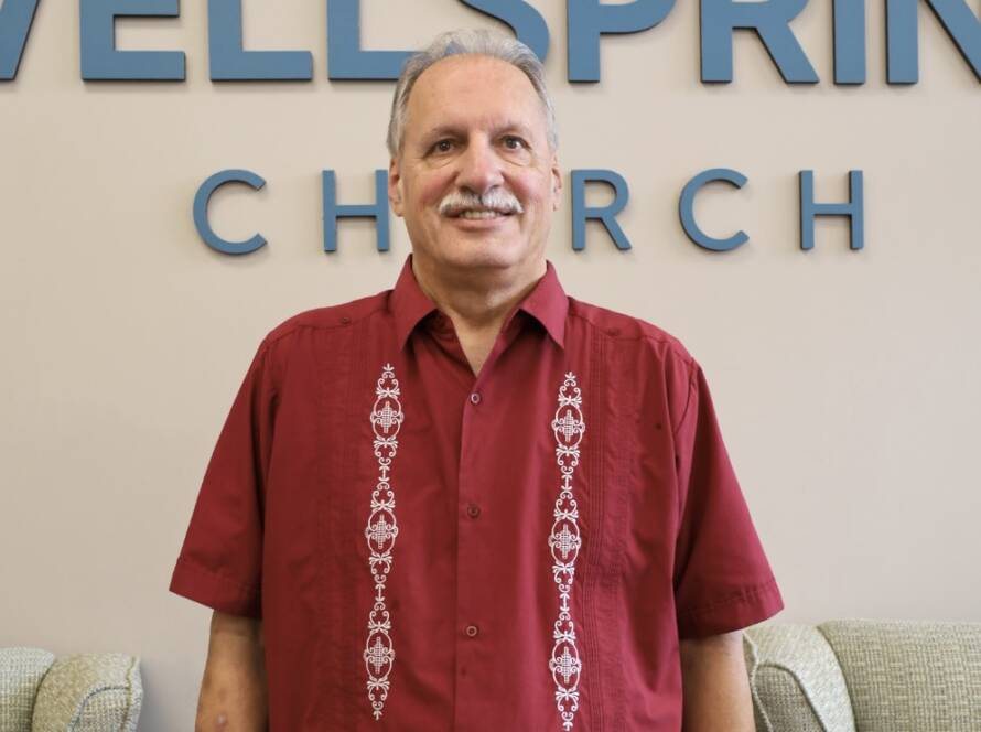 Smiling man in red embroidered shirt