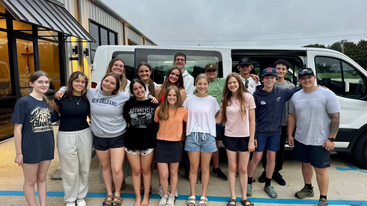 Teen group posing in front of white van